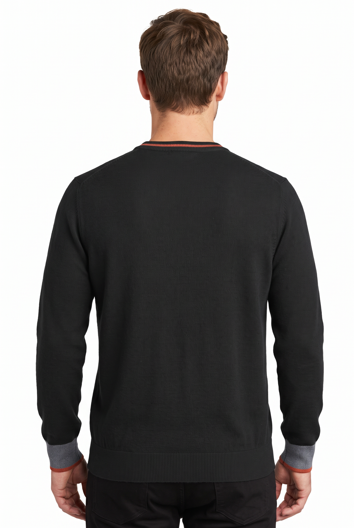 A man wearing a dark charcoal gray ribbed knit crewneck sweater with contrasting gray and brown ribbed cuffs, paired with brown trousers, against a plain white background.
